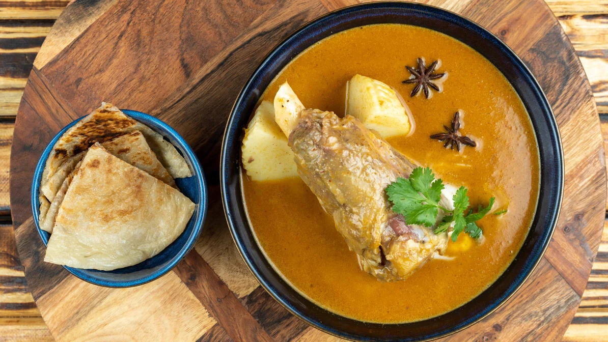 Slow-braised massaman lamb shank with roti at Marcoola Thai