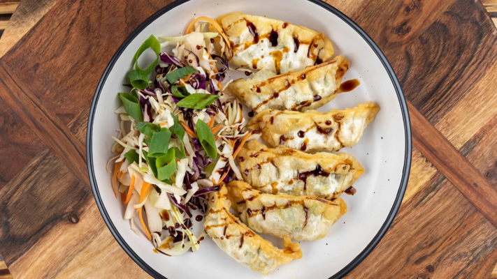 Pan-fried dumplings with Asian slaw and sweet soy